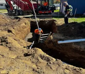 Adding stone and leveling prior to setting a drwell in the ground